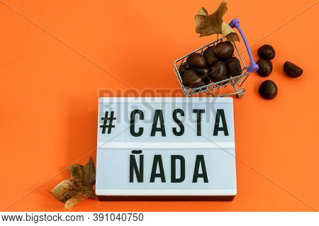 Ripe Chestnuts In Shopping Mini Basket And Text Castañada For Halloween Holiday.