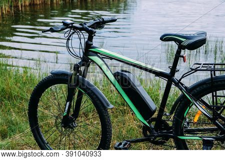 E-bike In The Park In Summer Day. The View Of The E Motor And Power Battery.