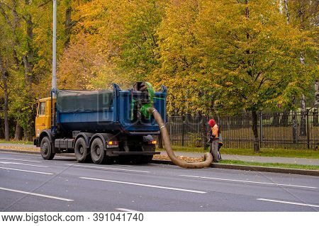 Moscow. Russia. October 11, 2020. Utility Workers Remove Yellow Autumn Leaves With An Industrial Vac