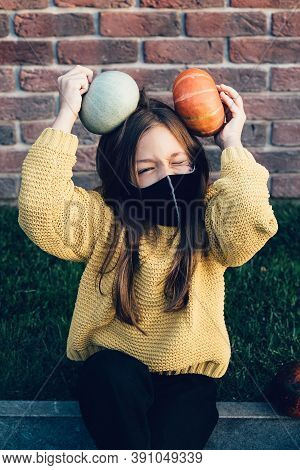 Kids Trick Or Treat In Halloween Costume And Face Mask. Coronavirus Halloween. Child Celebrates Holi