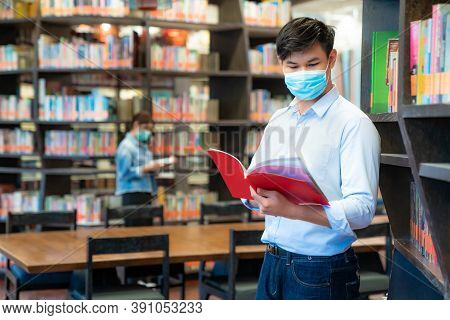 Two Asian University Students Wearing Face Mask And Standing In Library Social Distance From Other 6
