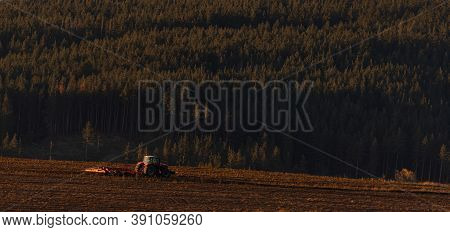 Tractor Moving Hay Field On Dark Wood And Mountain Background Forest Scenery Bulgaria Rural Copy Spa
