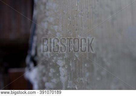 Ice And Snow On The Glass Wall Of House