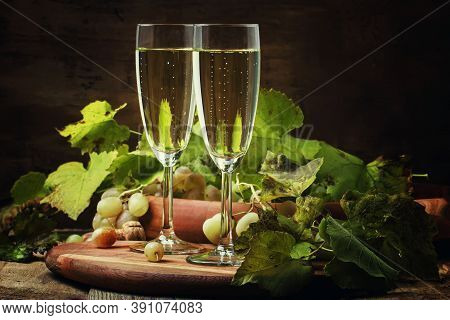 Champagne In Glasses, Grapes With Vine, Vintage Wood Background, Selective Focus
