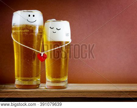 Two Glasses Of Beer With Painted Happy Couple And Red Heart On A String. Valentine Day, Happy Couple
