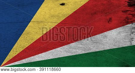 Flag Of Seychelles On Wooden Plate Background. Grunge Seychelles Flag Texture, Five Oblique Bands Of