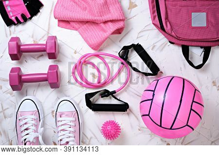 Sports Still Life In Top View With Pink Tones, Ball, Sneakers, Dumbbells, Backpack, Gloves, Rubber B