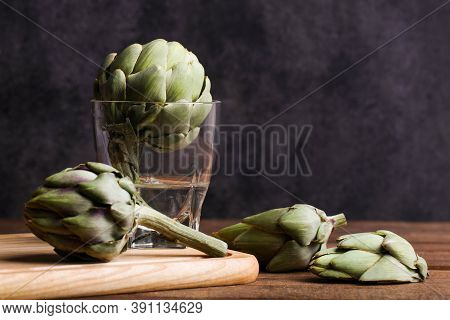 Fresh Artichokes In A Glass Of Water.