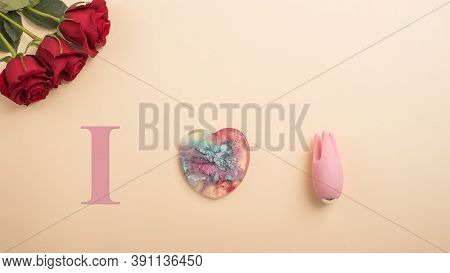 I Love To Masturbate. Rose Heart And Clitoral Vibrator On A Beige Background. Flat Lay