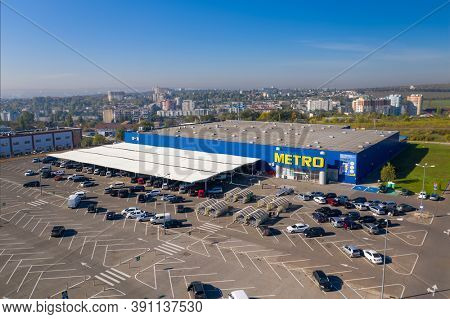 Chisinau, Moldova - October, 2020: Metro retail store, large shopping mall of household and food goods with parking, aerial view, copyspace