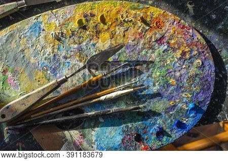 Painter Palette With Colours And Brushes