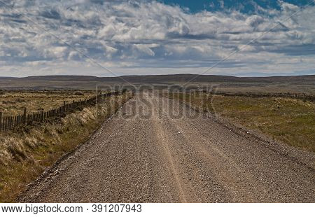 Punta Arenas, Chile - December 12, 2008: Brown Pebbles And Dirt Road To Riesco Island In Endless Dry