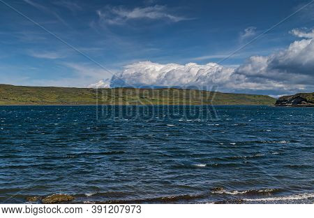 Punta Arenas, Chile - December 12, 2008: Blue Water Otway Sound Under Blue Sky With Large White Clou
