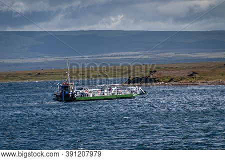 Punta Arenas, Chile - December 12, 2008: Green-white Ferry Crosses Blue Water Otway Sound Under Blue