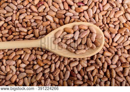 Top View Of One Wooden Spoon In Many Fresh Organic Red Beans In Warm Lightfood Photographed With Sof