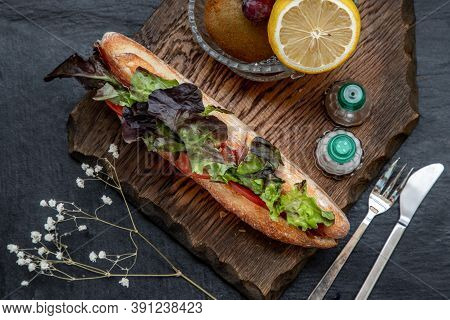 A Delicious Smoked Salmon Sesame Bread Sandwich With Fresh Fruit On A Wooden Plate. It Is Perfect Ea