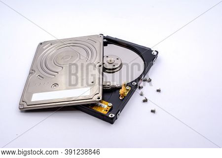 Opening Of Hard Disk For Data Recovery Isolated On White Background. Dismantled Hard Drive. Screwdri