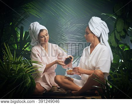 Portrait Of Young Beautiful Women Drinking Tea  In Spa Environment.