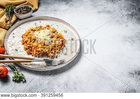 Orzo Pasta, Risone With Bolognese Sauce And Ground Beef In A Plate. Gray Background. Top View. Copy 