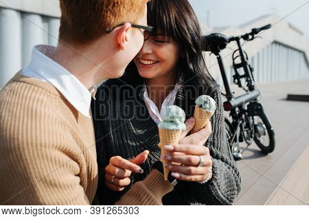 Carefree Couple Sitting Outdoor With Ice Cream, Smiling, Touching With Foreheads