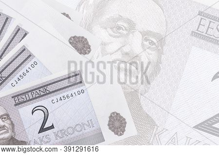 2 Estonian Kroon Bills Lies In Stack On Background Of Big Semi-transparent Banknote. Abstract Busine