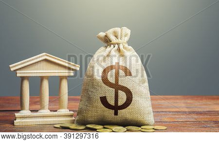 Dollar Money Bag And Bank / Government Building. Tax Collection And Budgeting. State Debt. Gdp And G