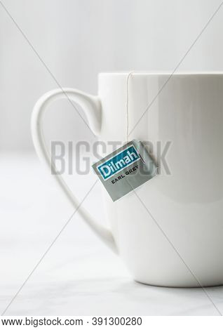 London, Uk - October 21, 2020: Dilmah Earl Grey Tea In White Ceramic Cup On Light Background. Macro