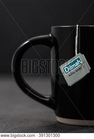 London, Uk - October 21, 2020: Dilmah Earl Grey Tea In Black Ceramic Cup On Dark Background.