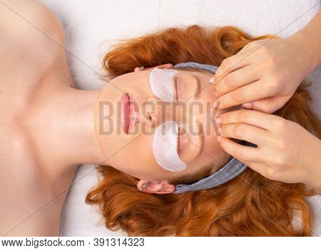 Spa. After Applying The Transparent Mask, The Beautician Does A Facial Massage. The Concept Of A Hea