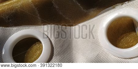 Plastic Rings For Attaching The Fabric To The Curtain Rod. White Plastic Organza Tulle Eyelets. Ligh