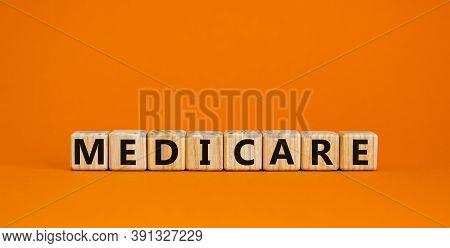 Wooden Cubes With Word 'medicare'. Beautiful Orange Background. Medical Concept. Copy Space.