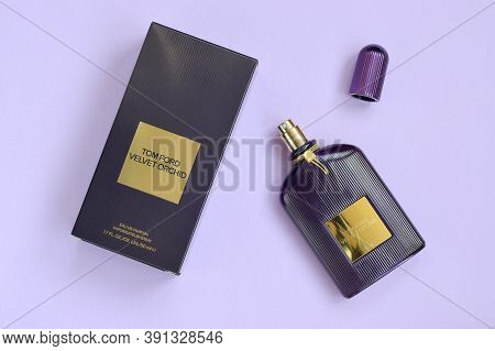 Tom Ford Velvet Orchid Fragrance Perfume Bottle Lies On Light Lilac Background. Tom Ford Is American