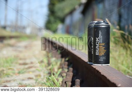 Used Montana Black Aerosol Spray Cans Against Graffiti Paintings. Mtn Or Montana-cans Is Manufacture