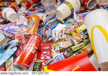 Many Wrappings And Cans From Used Products By Famous Worldwide Brands. Pattern Of Trash Of Various C