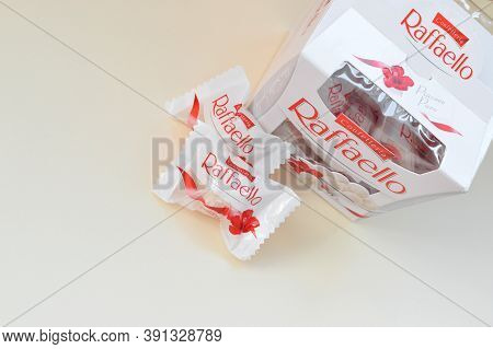Raffaello Candies On Beige Background. Raffaello Is A Spherical Coconut Almond Confection That Itali