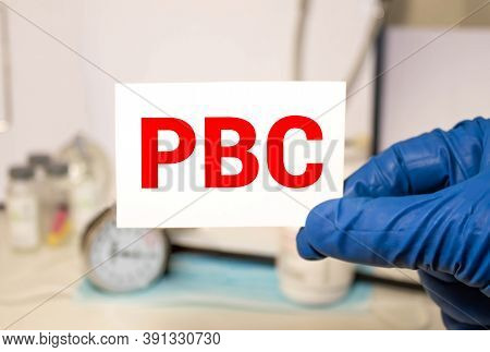 Doctor Holding A Paper Plate With Text Pbc, Medical Concept