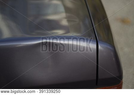 Dent On The Car. Deformation Of The Car Body. Damage To The Trunk.