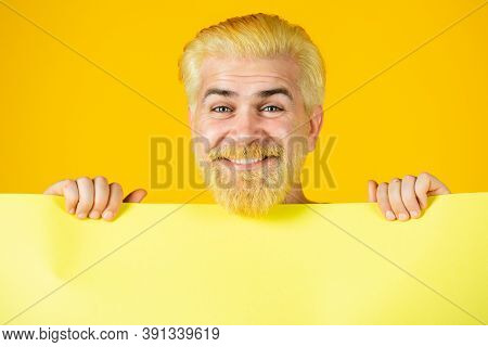 Happy Smiling Man Holding Blank Paper Board, Isolated Studio Portrait. Happy Man Holding Empty White
