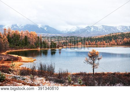 First Snow On The Autumn Kidelu Lake In Altai Mountains, Siberia, Russia. Snow-covered Mountain Peak