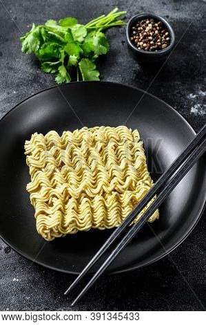 Dry, Raw Quick Cooking Noodle, Instant Noodles. Black Background. Top View