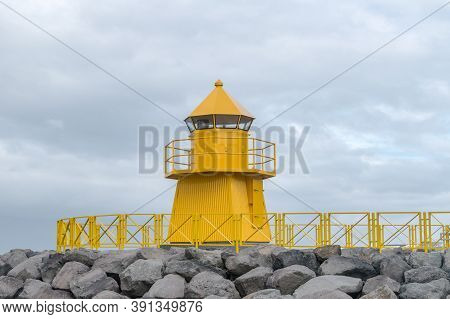 Yellow Hofdi Lighthouse In Reykjavik In Iceland.