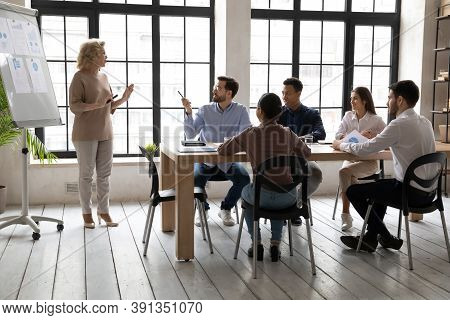 Middle-aged Businesswoman Talk Make Whitebeard Presentation At Meeting