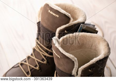 Lowa New Unisex Winter Shoes, Brown Boots With Wood Background. Buying Winter Shoes, Russia, Omsk, 2