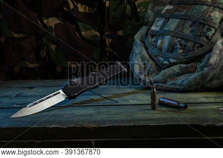 Sharp Knife And Cartridges. Army Uniform, Knives And Casings.