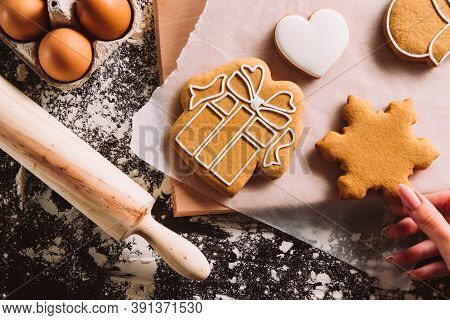 Festive Decorated Bakery. Christmas Cookies. Gingerbread Biscuits. Unrecognizable Female Hand Homema