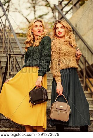 Vogue Concept. Girls Blonde Wear Matching Clothes. Matching Outfits. Women Sisters Outdoors Stairs B