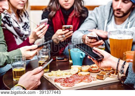Side Angle View Of Hands With Cellphones At Beer Bar Restaurant - People Sharing Time Together With 