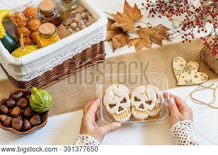 Female Hands Packing Halloween Presents. Some Spice, Chestnuts, Scull Biscuits, Panelles De Piñones 