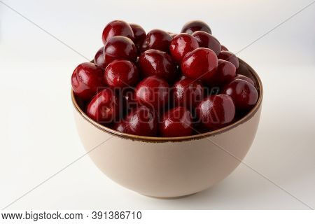 Ripe Cherries In A Bowl On A White Background