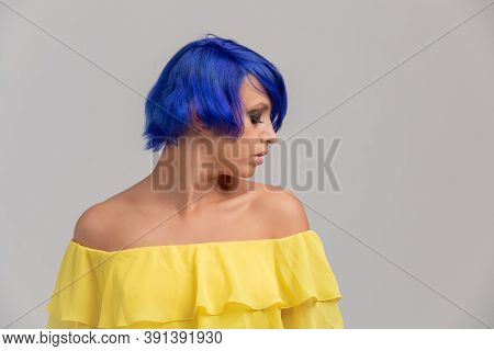 Portrait Of A Woman With Bright Colored Flying Hair, Blue Haircut. Hair Coloring, Girl With Short Ha